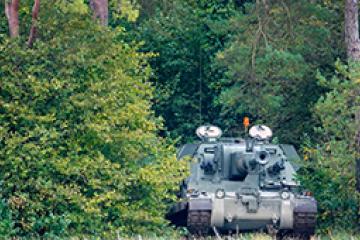 AS 90 Self Propelled Howitzer Gun amongst trees whilst on maneuvers